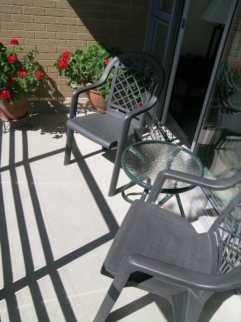 Furnished patio with outdoor furniture and potted flowers, perfect for relaxing. - 1035 Marinaside Crescent, Vancouver Downtown