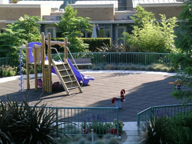 Spacious outdoor patio with playground equipment and lush greenery. - 1035 Marinaside Crescent, Vancouver Downtown