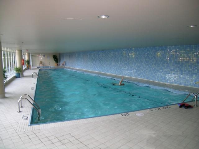 Spacious indoor pool area with tiled walls and a relaxing ambiance. - 1035 Marinaside Crescent, Vancouver Downtown