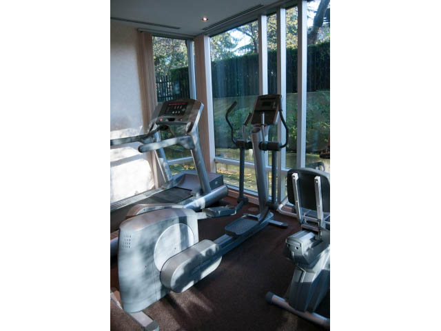 Bright living room with exercise equipment and large windows. - 1804 - 1003 Burnaby Street, Vancouver Downtown