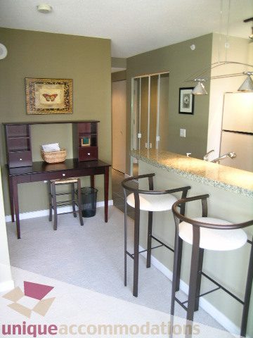 Furnished dining area with modern bar stools and glass-top table. - 707 - 1068 Hornby Street, Vancouver Downtown