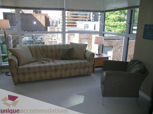 Furnished living room with large windows, city view, and modern furniture. - 707 - 1068 Hornby Street, Vancouver Downtown