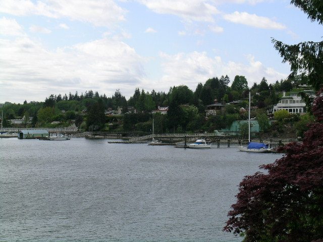 Spacious living room with a view of the water and docked boats. - 4527 Stonehaven Avenue, North Vancouver