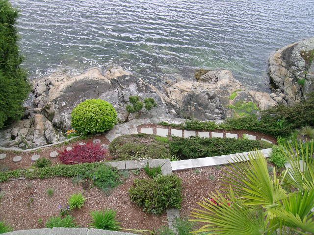 Bright living room with ocean view and stone pathways. - 4527 Stonehaven Avenue, North Vancouver