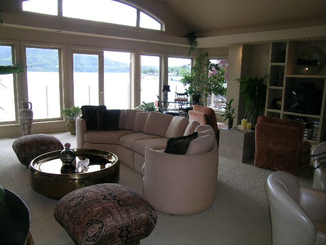 Spacious living room with large windows, view of water, and plush furniture. - 4527 Stonehaven Avenue, North Vancouver