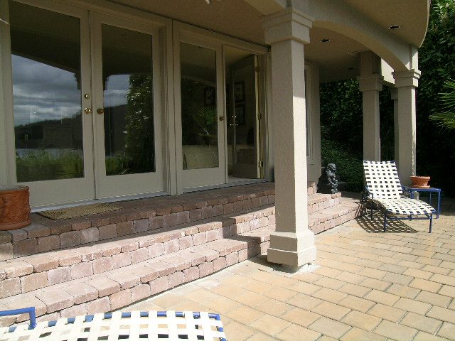 Furnished patio with brick steps, outdoor furniture, and garden view. - 4527 Stonehaven Avenue, North Vancouver