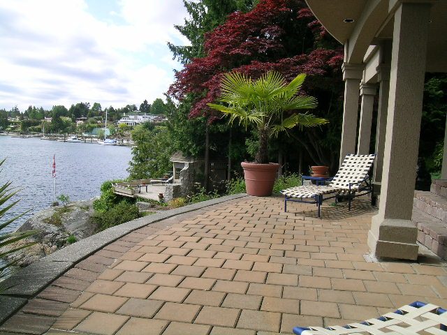 Furnished patio with brick paving, overlooking a serene waterfront. - 4527 Stonehaven Avenue, North Vancouver