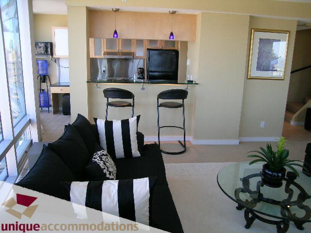 Bright kitchen with black bar stools, hardwood floors, and city view. - 1808 - 1003 Burnaby Street, Vancouver Downtown
