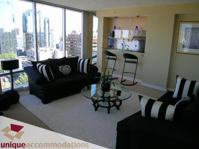 Bright living room with city view, modern furnishings, and open kitchen area. - 1808 - 1003 Burnaby Street, Vancouver Downtown