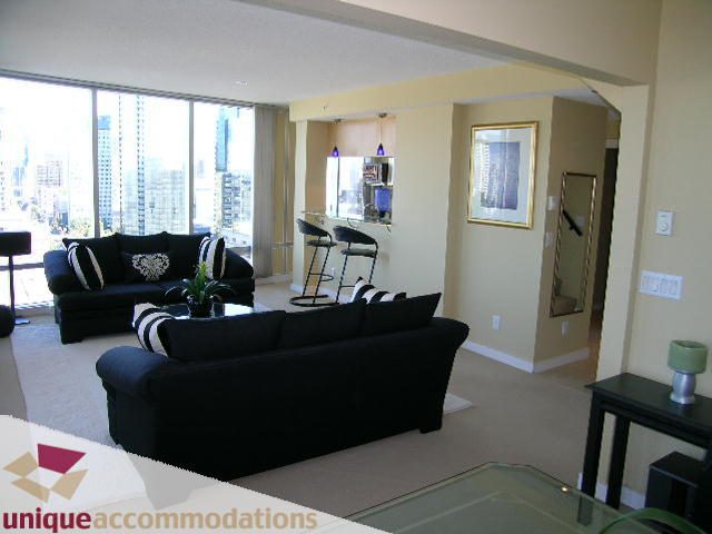 Spacious living room with black furniture and city view. - 1808 - 1003 Burnaby Street, Vancouver Downtown
