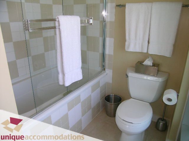 Bright bathroom with white towels, modern shower, and toilet. - 1808 - 1003 Burnaby Street, Vancouver Downtown