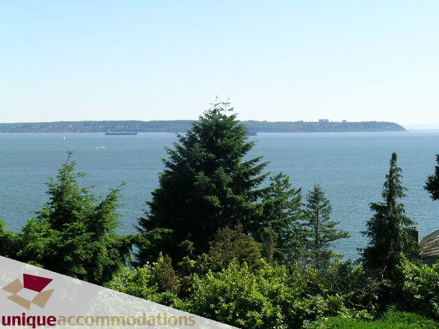Furnished living room with stunning city view and lush greenery. - 3664 Creery Ave., West Vancouver