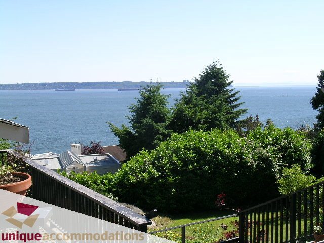 Bright living room with stunning ocean view and lush greenery. - 3664 Creery Ave., West Vancouver