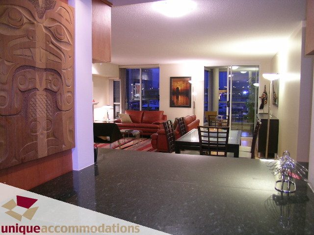 Furnished living room with hardwood floors, city view, and modern decor. - 322 - 1228 Marinaside Crescent, Vancouver Downtown