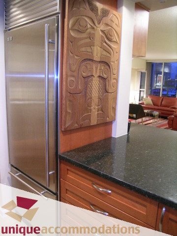Furnished kitchen with granite countertops and wooden cabinets. - 322 - 1228 Marinaside Crescent, Vancouver Downtown