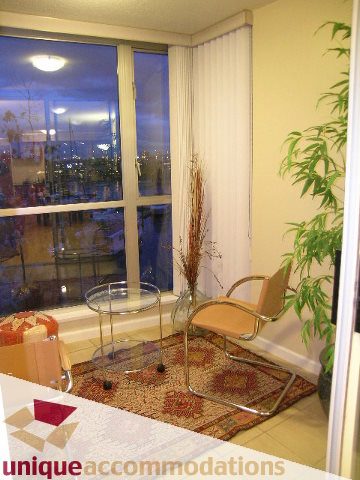 Furnished living room with city view and modern furniture. - 322 - 1228 Marinaside Crescent, Vancouver Downtown