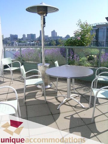 Furnished patio with outdoor seating and city view. - 322 - 1228 Marinaside Crescent, Vancouver Downtown