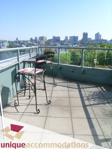 Furnished rooftop patio with city view and metal furniture. - 322 - 1228 Marinaside Crescent, Vancouver Downtown