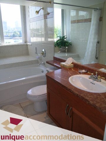 Spacious bathroom with marble countertops, city view, and modern fixtures. - 322 - 1228 Marinaside Crescent, Vancouver Downtown