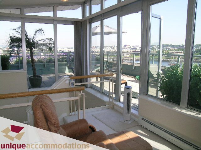 Furnished living room with city view and large windows. - 322 - 1228 Marinaside Crescent, Vancouver Downtown
