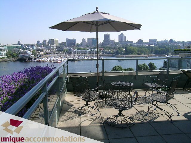 Furnished patio with city view, waterfront, and outdoor seating. - 322 - 1228 Marinaside Crescent, Vancouver Downtown