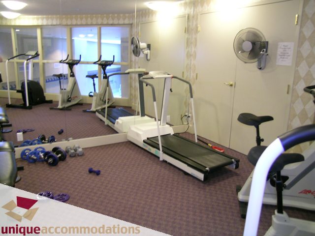 Fitness room with cardio equipment and mirrors. - 322 - 1228 Marinaside Crescent, Vancouver Downtown