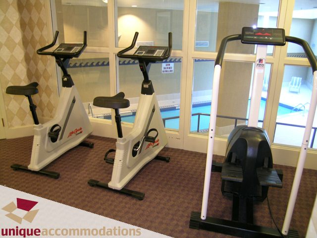 Fitness room with exercise bikes and treadmills, modern decor. - 322 - 1228 Marinaside Crescent, Vancouver Downtown