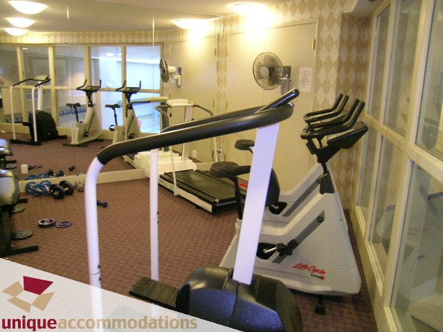 Fitness room with cardio equipment and mirrors. - 322 - 1228 Marinaside Crescent, Vancouver Downtown
