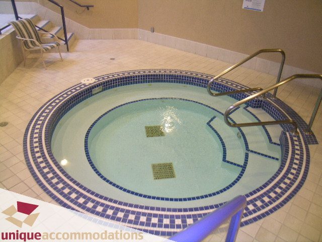 Spacious hot tub with mosaic tile design and handrails. - 322 - 1228 Marinaside Crescent, Vancouver Downtown