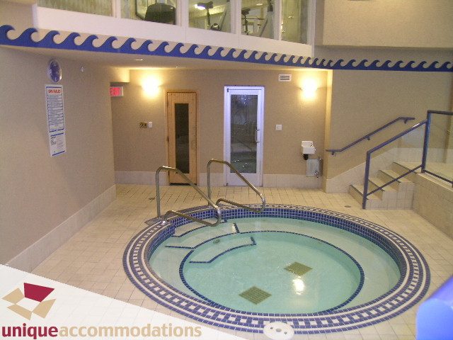 Spacious indoor pool area with tiled floors and blue mosaic accents. - 322 - 1228 Marinaside Crescent, Vancouver Downtown