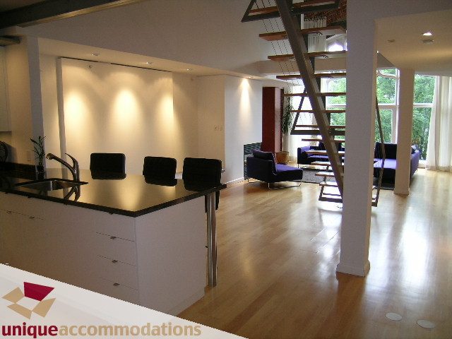 Bright kitchen with modern furnishings, hardwood floors, and a city view. - 401 - 2525 Quebec Street, Vancouver East Side