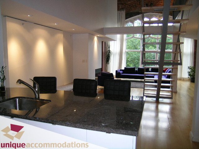 Bright kitchen with granite countertops, hardwood floors, and a city view. - 401 - 2525 Quebec Street, Vancouver East Side