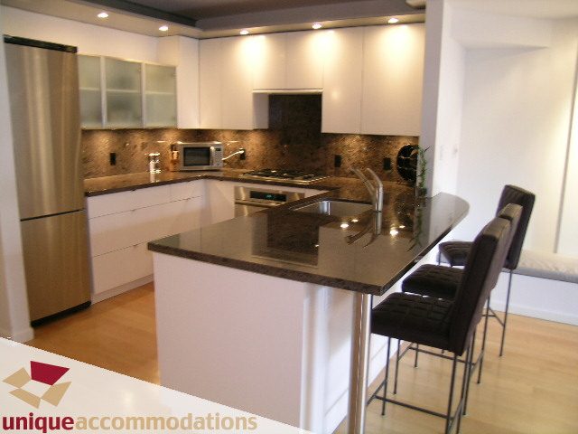Bright kitchen with granite countertops, stainless steel appliances, and hardwood floors. - 401 - 2525 Quebec Street, Vancouver East Side