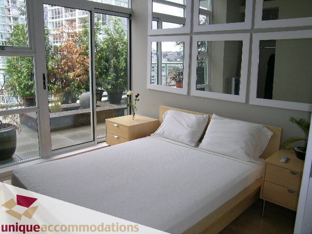 Bright bedroom with large windows, city view, and modern furnishings. - 2502 - 1077 Marinaside Crescent, Vancouver Downtown