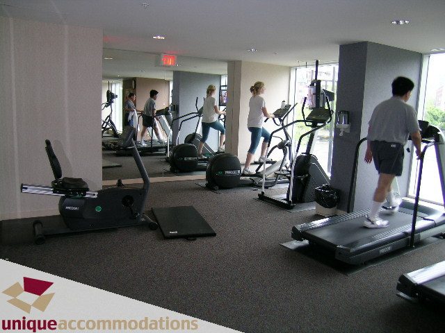 Bright fitness room with cardio equipment and large windows. - 2502 - 1077 Marinaside Crescent, Vancouver Downtown