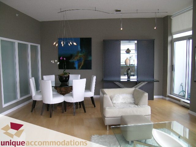Furnished living room with modern furniture, hardwood floors, and large windows. - 2502 - 1077 Marinaside Crescent, Vancouver Downtown