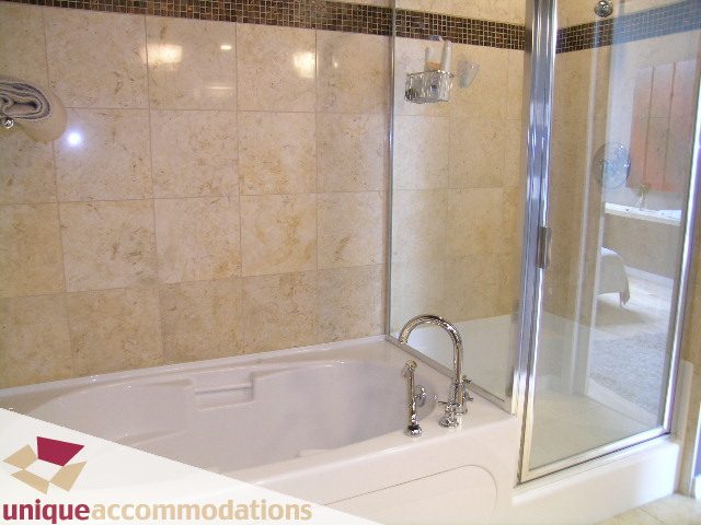 Spacious bathroom with marble tiles and a glass shower door. - 2502 - 1077 Marinaside Crescent, Vancouver Downtown