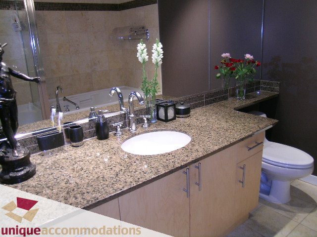 Furnished bathroom with granite countertops and modern fixtures. - 2502 - 1077 Marinaside Crescent, Vancouver Downtown