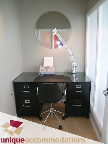 Bright office with glass desk, black filing cabinet, and desk lamp. - 2502 - 1077 Marinaside Crescent, Vancouver Downtown