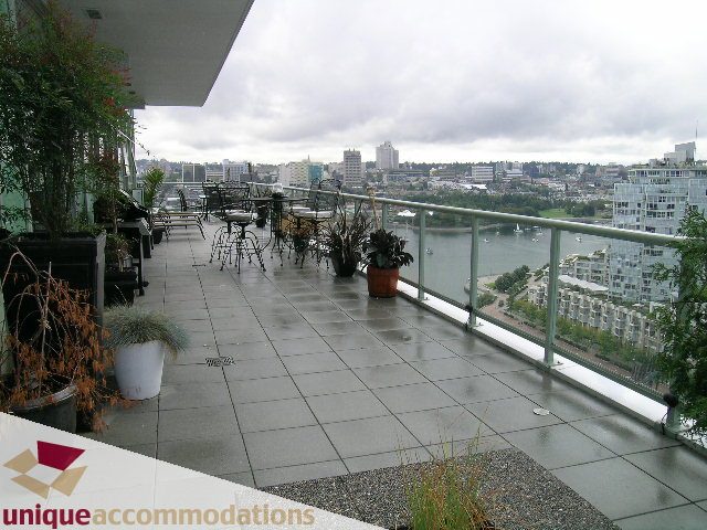 Furnished balcony with city view and potted plants. - 2502 - 1077 Marinaside Crescent, Vancouver Downtown