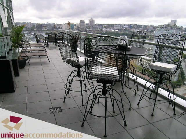 Furnished rooftop patio with city view and outdoor seating. - 2502 - 1077 Marinaside Crescent, Vancouver Downtown