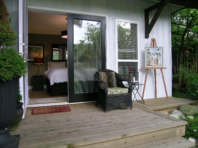 Bright and airy 1-bedroom suite with a cozy balcony, wooden deck, and outdoor seating. - 470 Ellis Street, North Vancouver