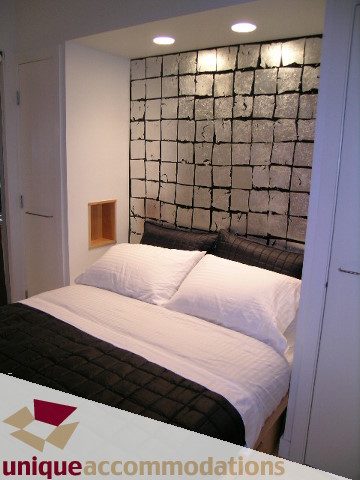 Furnished 2-bedroom loft with modern wall art and cozy bedding. - 409 - 1072 Hamilton Street, Vancouver Downtown