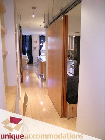 Bright kitchen with hardwood floors and sliding door leading to living area. - 409 - 1072 Hamilton Street, Vancouver Downtown