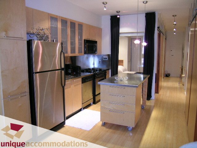 Bright kitchen with stainless steel appliances and hardwood floors. - 409 - 1072 Hamilton Street, Vancouver Downtown