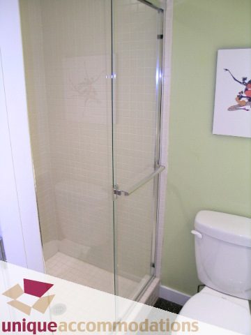 Bathroom with glass shower and light green walls. - 409 - 1072 Hamilton Street, Vancouver Downtown