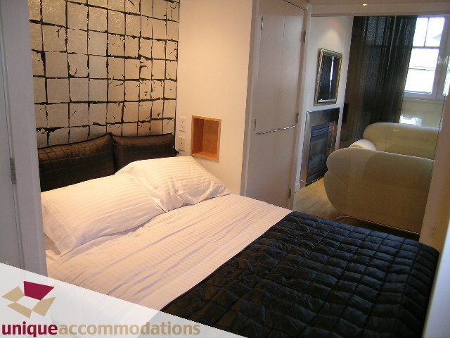 Bright and cozy loft bedroom with white bedding and black accents, modern decor. - 409 - 1072 Hamilton Street, Vancouver Downtown