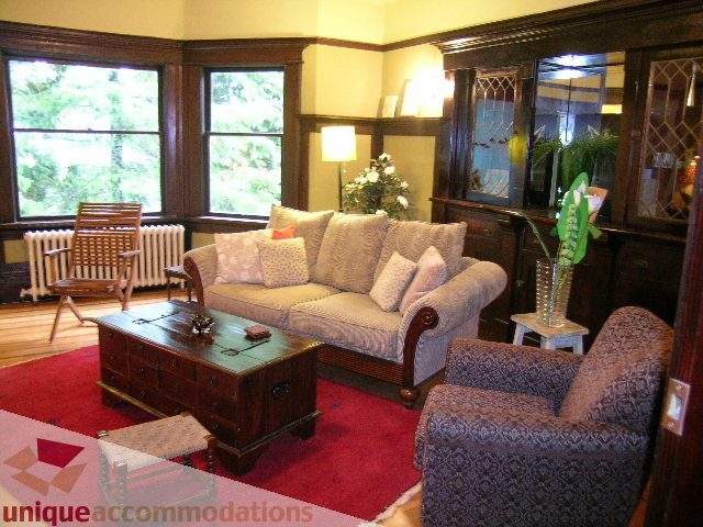 Living room with large windows, hardwood floors, and a cozy sofa set. - 3 - 2812 Yukon, Vancouver West Side