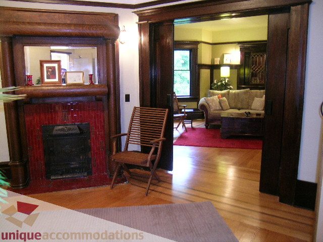 Furnished living room with hardwood floors, fireplace, and large mirror. - 3 - 2812 Yukon, Vancouver West Side