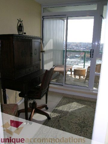 Furnished living room with city view and wooden furniture. - 3607 - 1033 Marinaside Crescent, Vancouver Downtown
